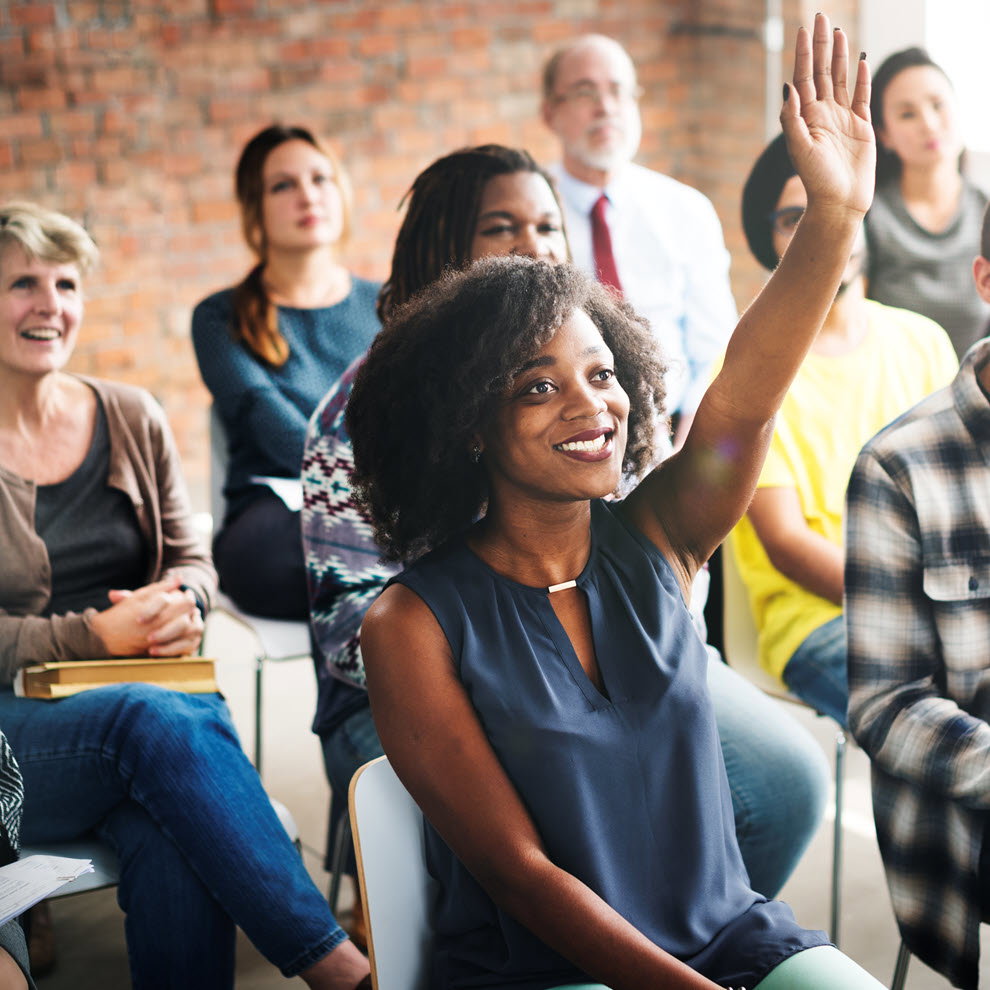 Classroom of students with student raising their hand
