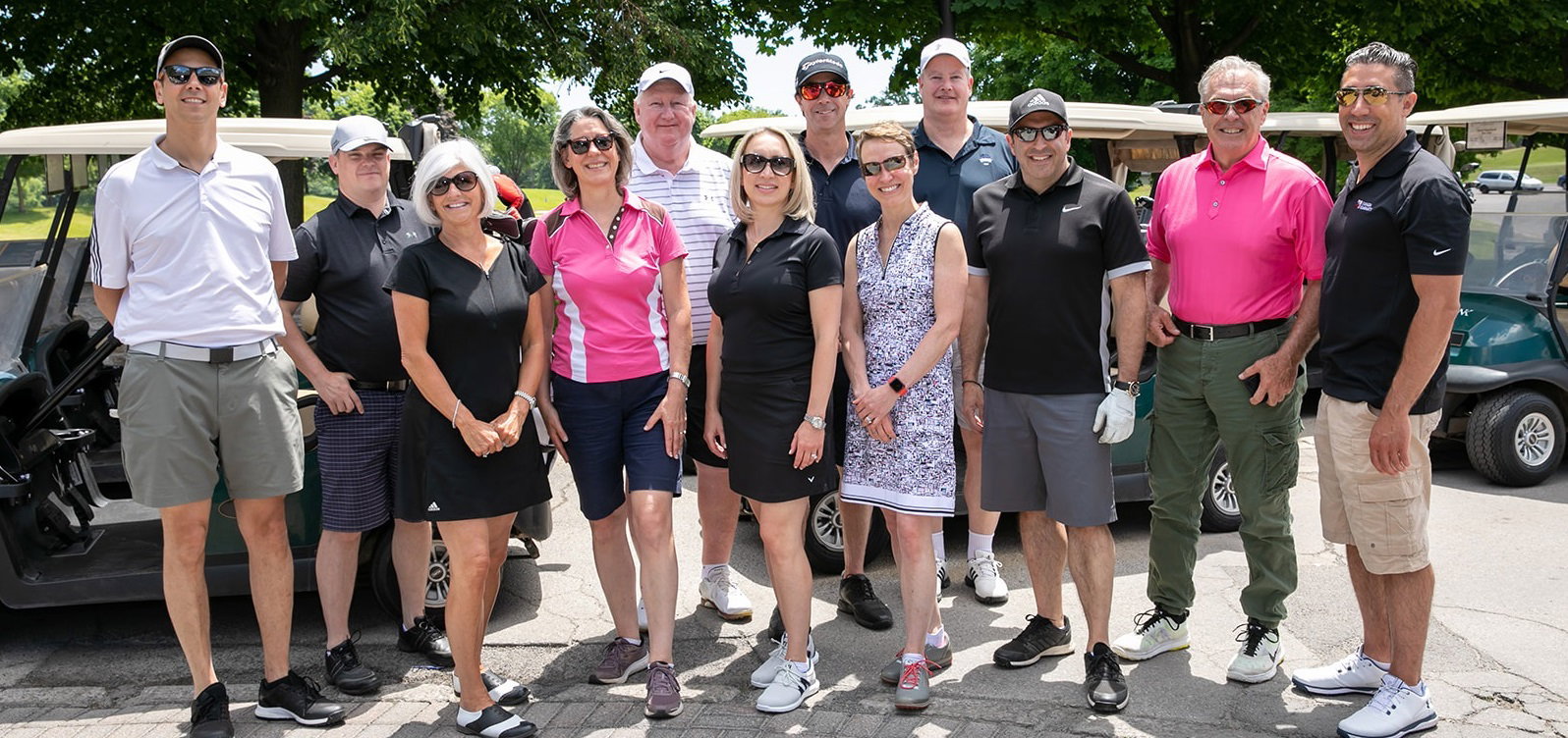 Group of golfers posing for a photo at MPC charity golf tournament