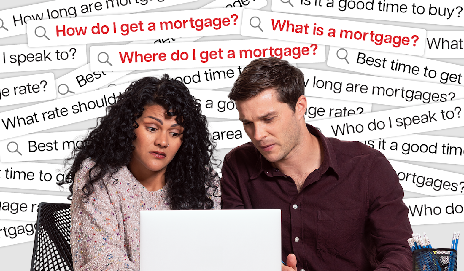 Two people looking at a computer screen confused about their mortgage