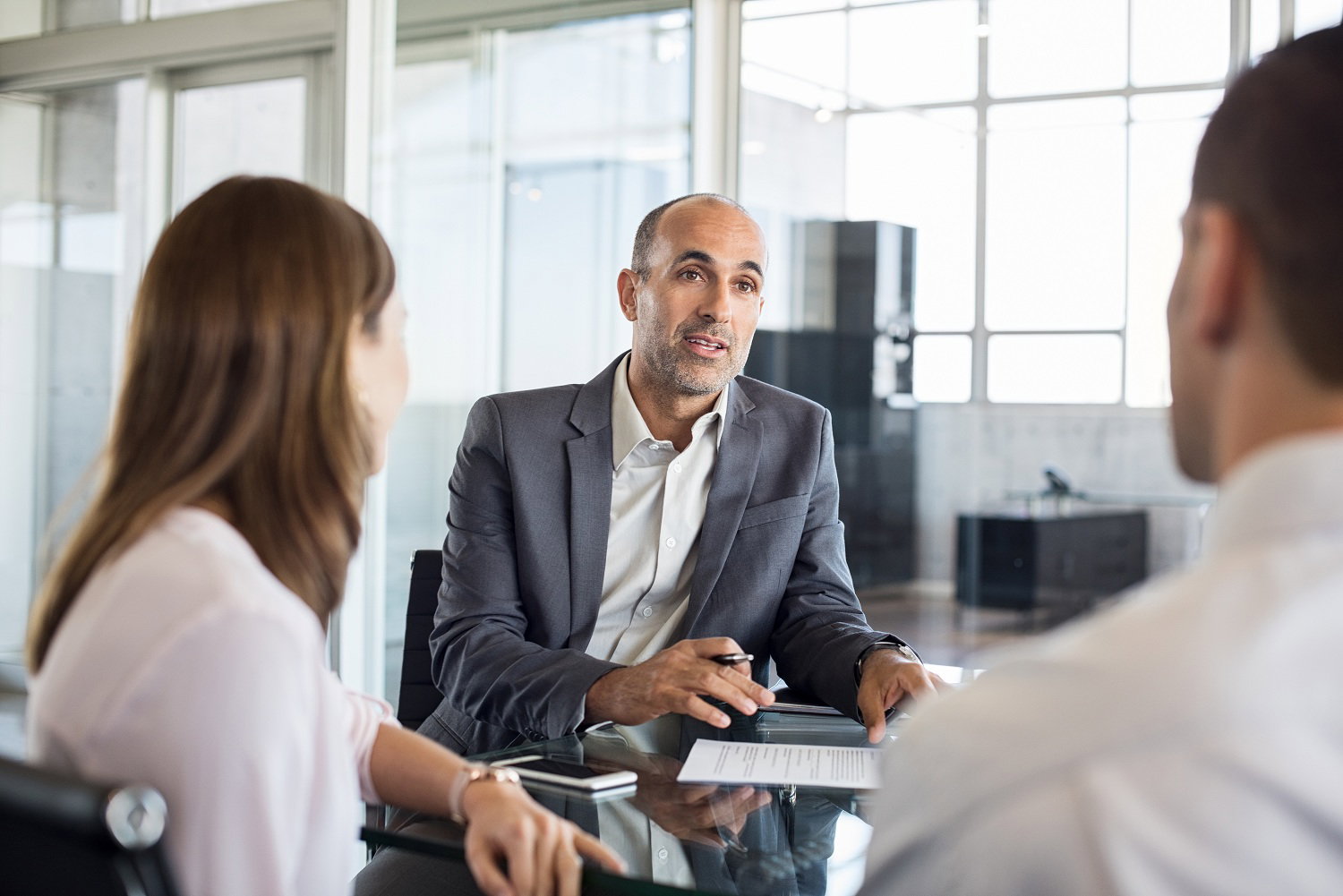 Homeowners reviewing mortgage and insurance options with their mortgage broker