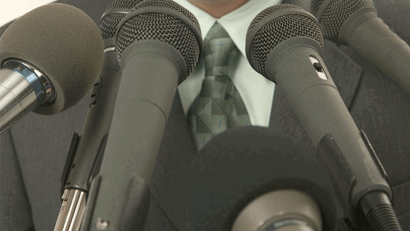 Man speaking at a microphone